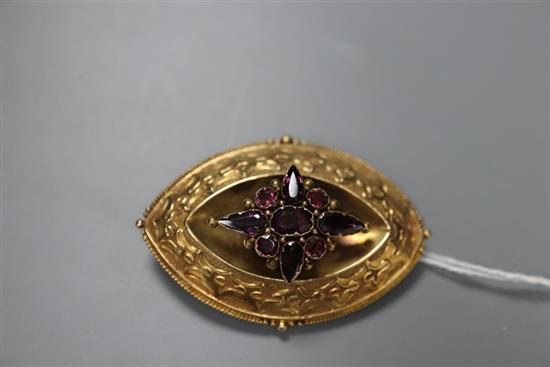A Victorian yellow metal and garnet set navette shaped brooch, 52mm, gross 14.9 grams.